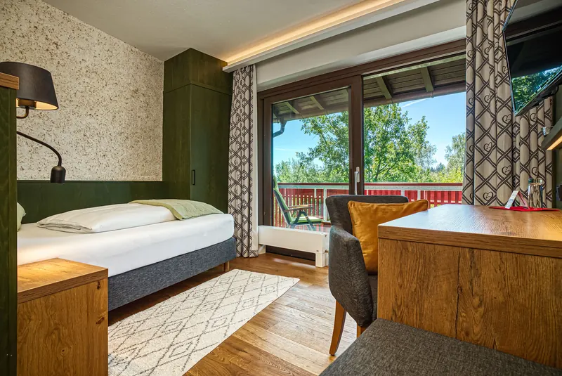 Modernes Hotelzimmer mit grüner Wand und Ausblick
